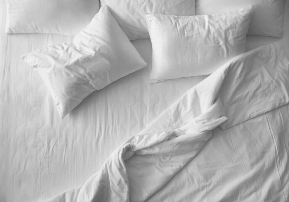 White sheets and pillows on a bed
